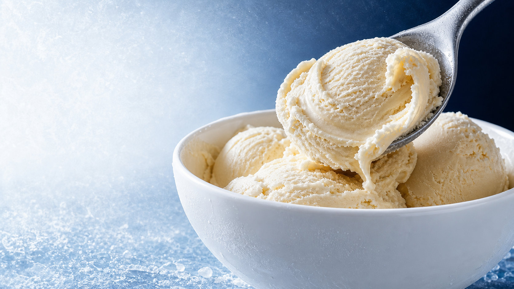 A spoon scooping creamy ice cream from a bowl